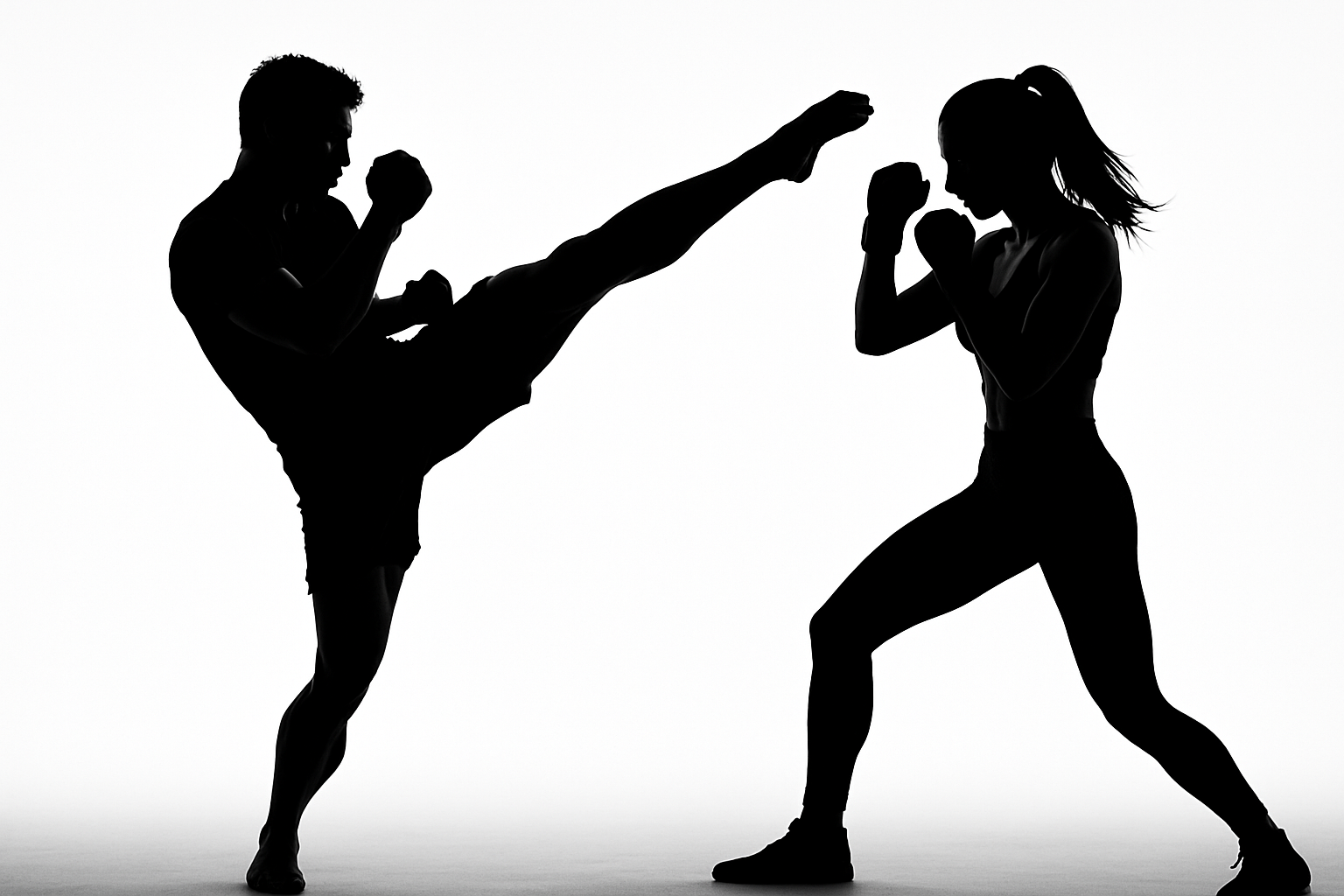 Silhouette of man and woman in kickboxing pose